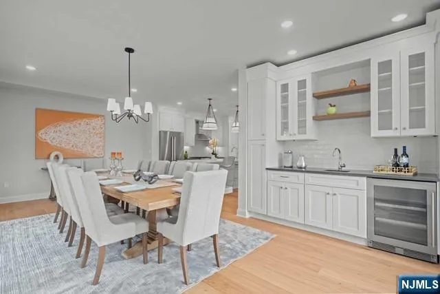 a view of a dining room with furniture and chandelier
