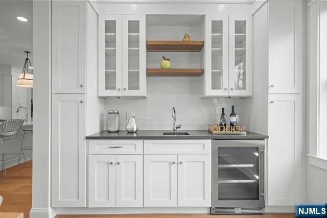 a kitchen with stainless steel appliances granite countertop a sink and cabinets