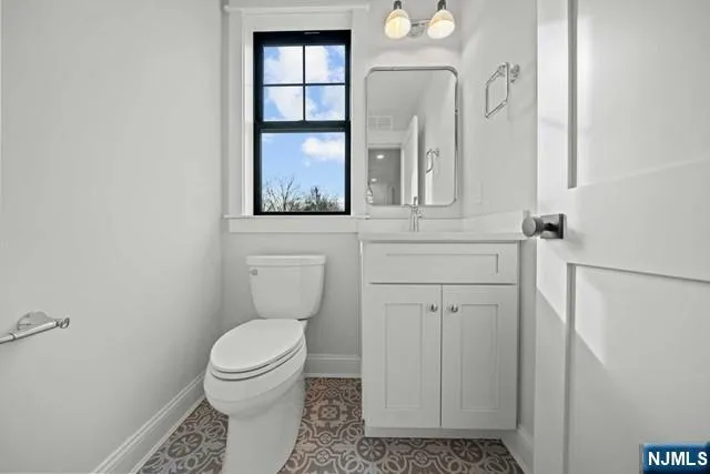 a bathroom with a toilet a sink and a mirror