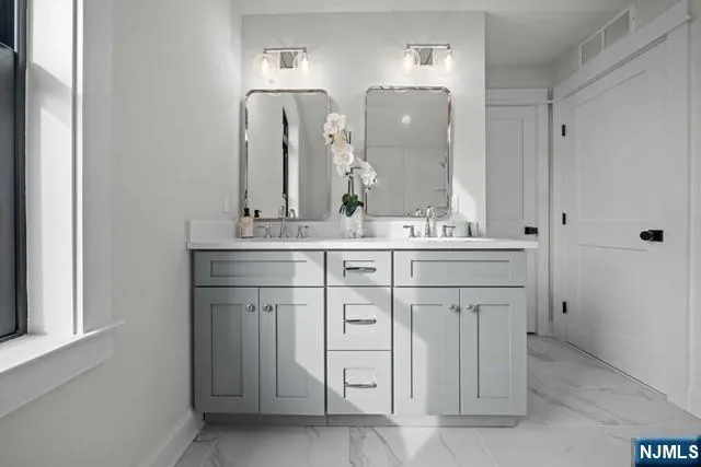 a bathroom with a double vanity sink and mirror