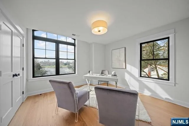a dining room with furniture a rug and wooden floor