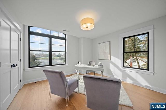 147 Central Avenue, Unit 20 Old Tappan, NJ 07675 - Photo 30 of 50 a dining room with furniture a rug and wooden floor