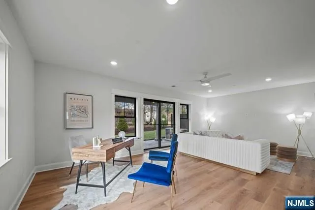 a living room with furniture and large window