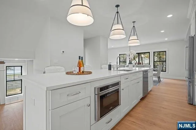 a kitchen with a counter space a sink appliances and cabinets