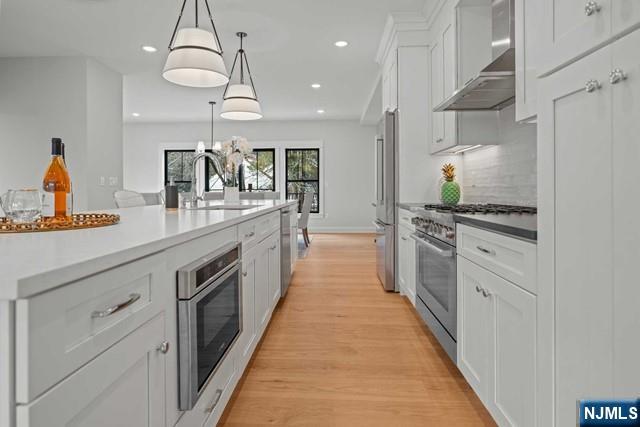 147 Central Avenue, Unit 20 Old Tappan, NJ 07675 - Photo 8 of 50 a large kitchen with stainless steel appliances kitchen island granite countertop a stove a sink and a refrigerator