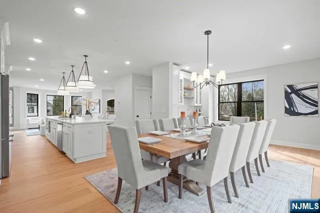 a dining room with furniture a chandelier and window