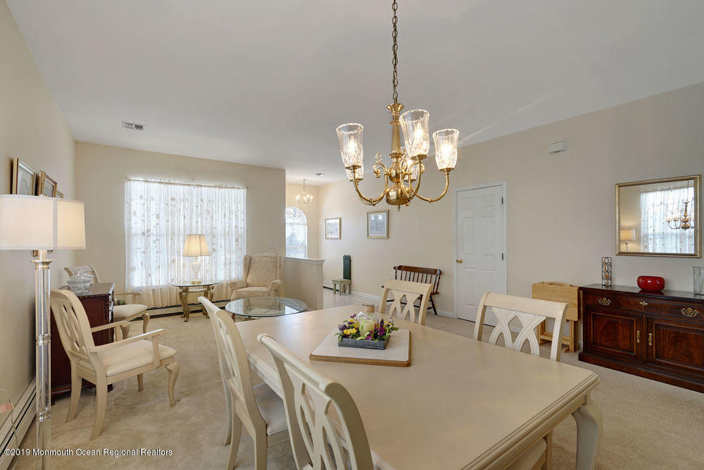 47 Wordsworth Road Brick, NJ 08724 - Photo 14 of 42 a view of a dining room with furniture a chandelier and a window