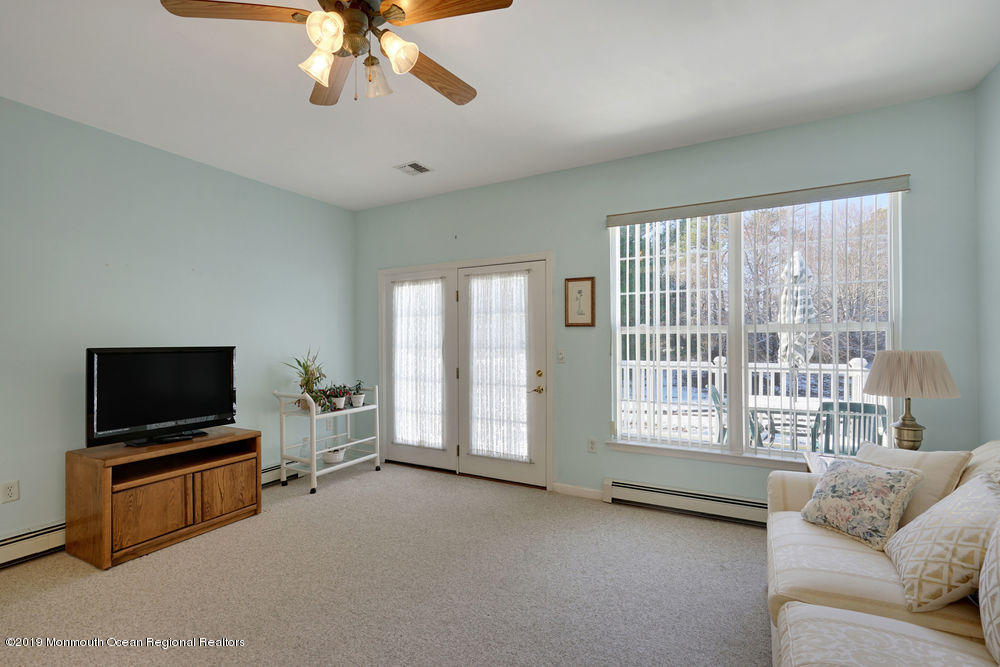 47 Wordsworth Road Brick, NJ 08724 - Photo 22 of 42 a living room with furniture and a flat screen tv