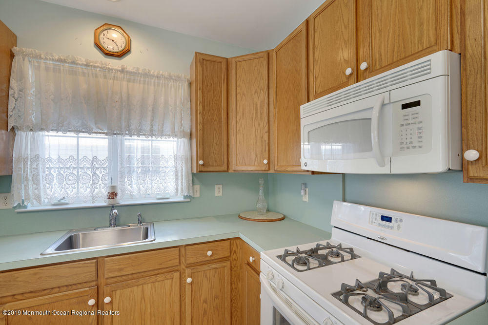 47 Wordsworth Road Brick, NJ 08724 - Photo 25 of 42 a kitchen with a cabinets a stove a sink and a window