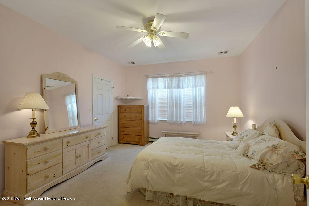 47 Wordsworth Road Brick, NJ 08724 - Photo 32 of 42 a bedroom with a bed and a chandelier
