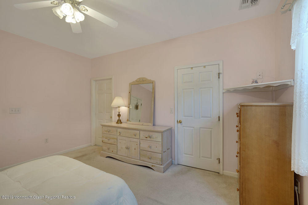 47 Wordsworth Road Brick, NJ 08724 - Photo 34 of 42 a bedroom with a bed and a chandelier
