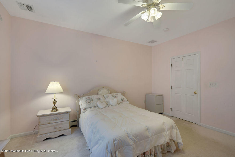 47 Wordsworth Road Brick, NJ 08724 - Photo 35 of 42 a bedroom with a bed and a chandelier