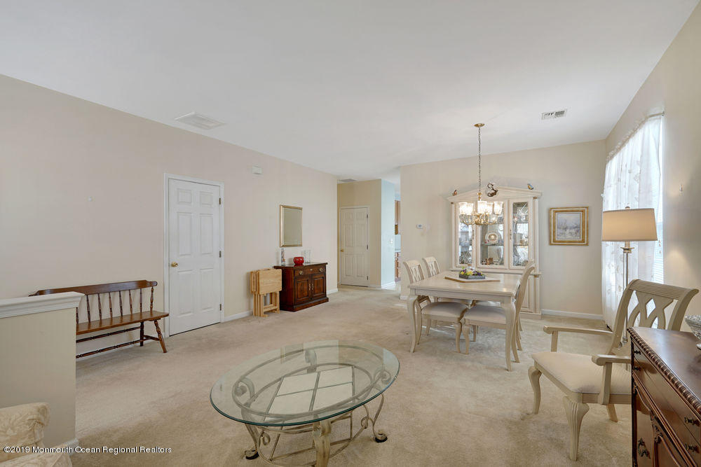 47 Wordsworth Road Brick, NJ 08724 - Photo 9 of 42 a living room with furniture a dining table and a chandelier