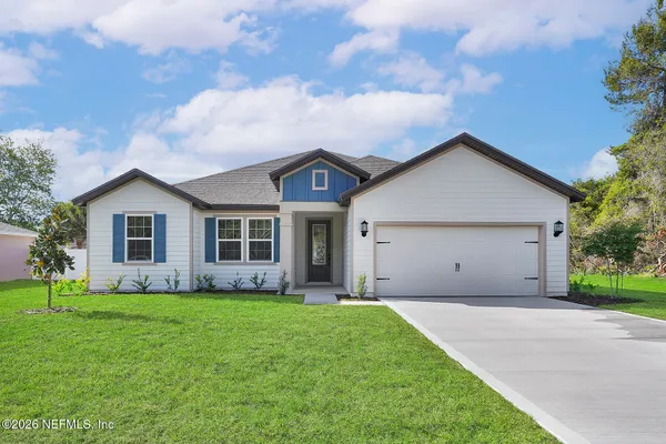 a front view of house with yard and green space
