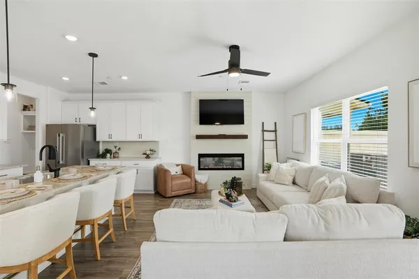 a living room with furniture a fireplace and a flat screen tv