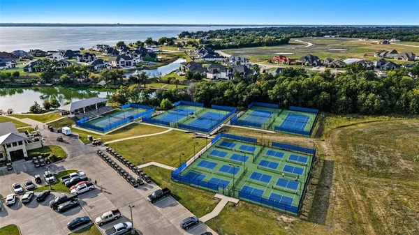 a view of a swimming pool with lawn chairs under an umbrella