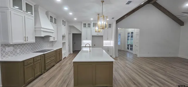 a large kitchen with stainless steel appliances kitchen island a large island in the center