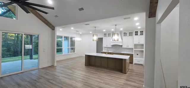 a view of kitchen with cabinets and wooden floor