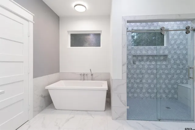 a spacious bathroom with a granite countertop sink mirror and toilet