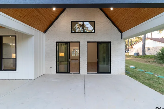 a view of house with a backyard