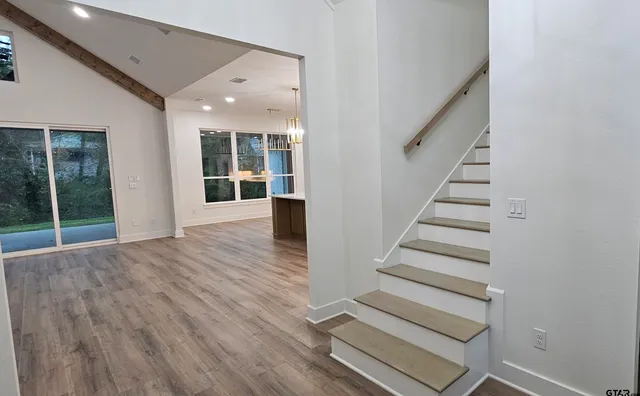 a view of staircase with white walls and windows