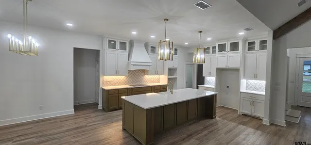 a kitchen with kitchen island a sink stainless steel appliances and counter space