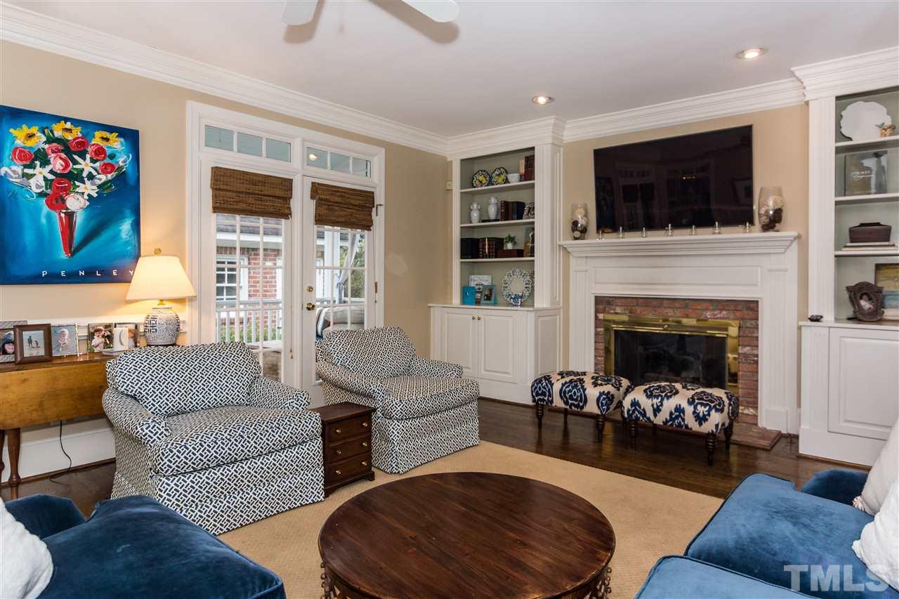 1712 Craig Street Raleigh, NC 27608 - Photo 13 of 25 a living room with furniture fireplace and flat screen tv