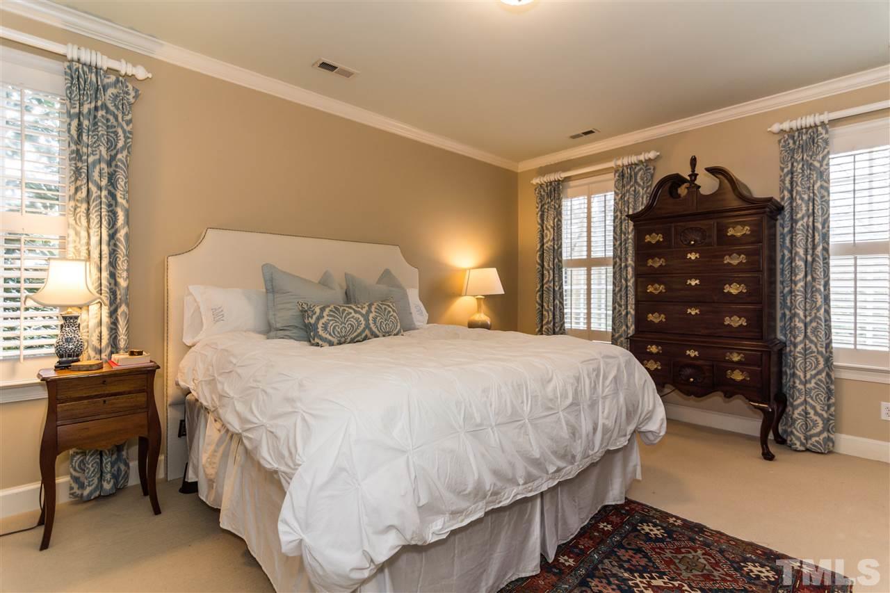 1712 Craig Street Raleigh, NC 27608 - Photo 14 of 25 a bedroom with a bed and a table
