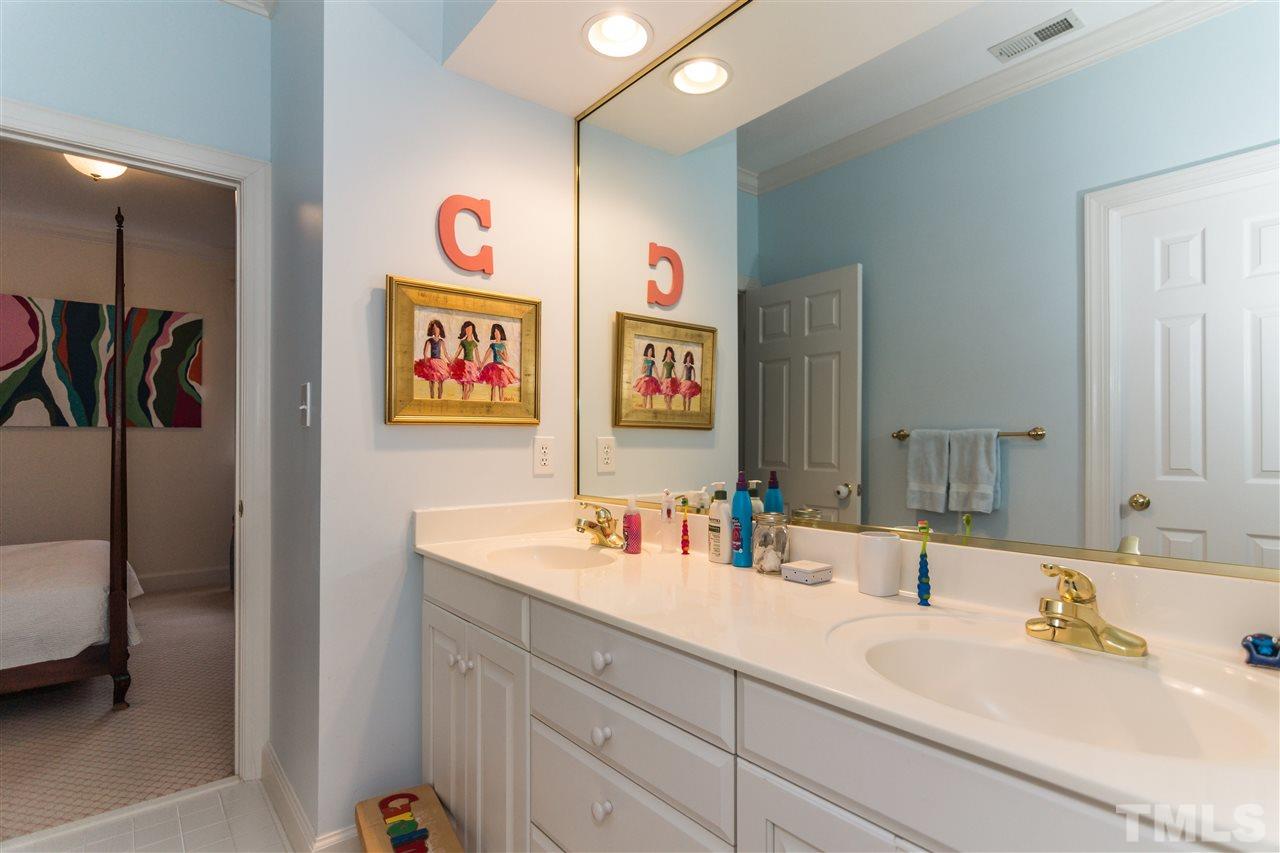 1712 Craig Street Raleigh, NC 27608 - Photo 16 of 25 a bathroom with double vanity and a sink