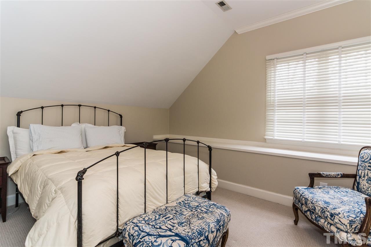 1712 Craig Street Raleigh, NC 27608 - Photo 18 of 25 a bedroom with a bed and a window