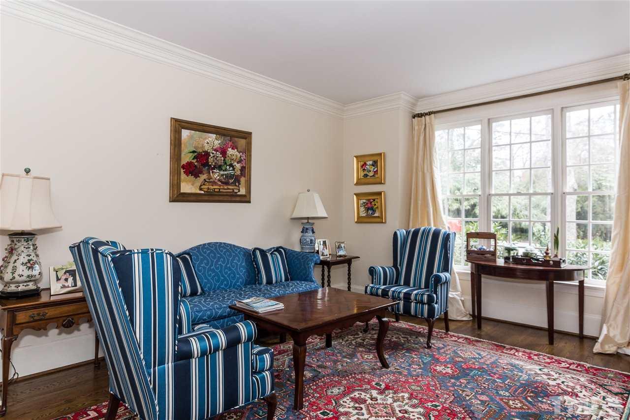 1712 Craig Street Raleigh, NC 27608 - Photo 3 of 25 a living room with furniture a large window and a potted plant