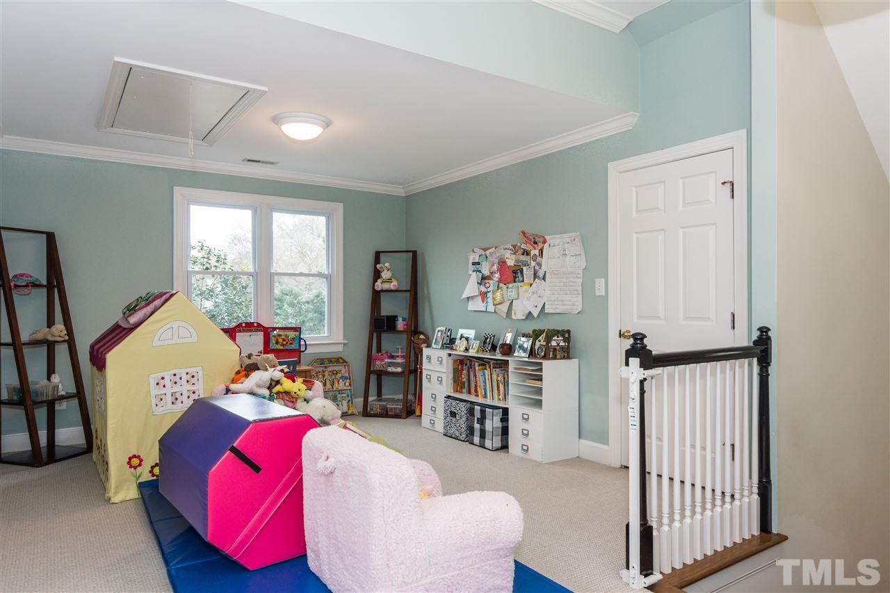 1712 Craig Street Raleigh, NC 27608 - Photo 21 of 25 a bedroom with furniture and a window