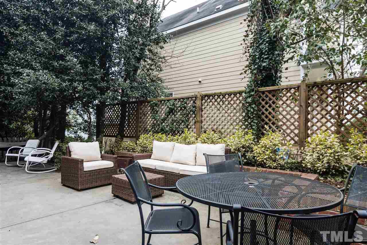 1712 Craig Street Raleigh, NC 27608 - Photo 23 of 25 a view of a patio with a table and chairs and a fire pit
