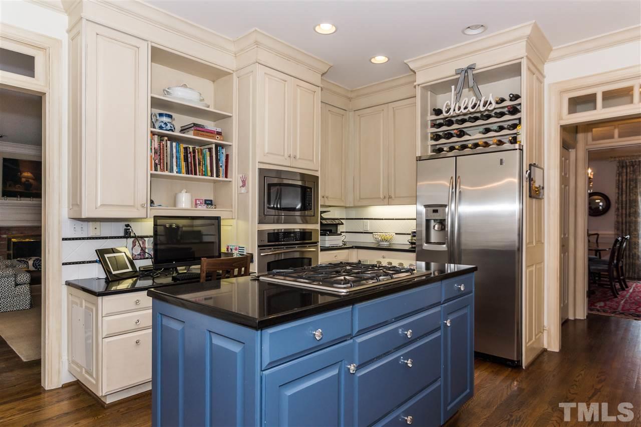 1712 Craig Street Raleigh, NC 27608 - Photo 5 of 25 a kitchen with granite countertop a sink stainless steel appliances and cabinets