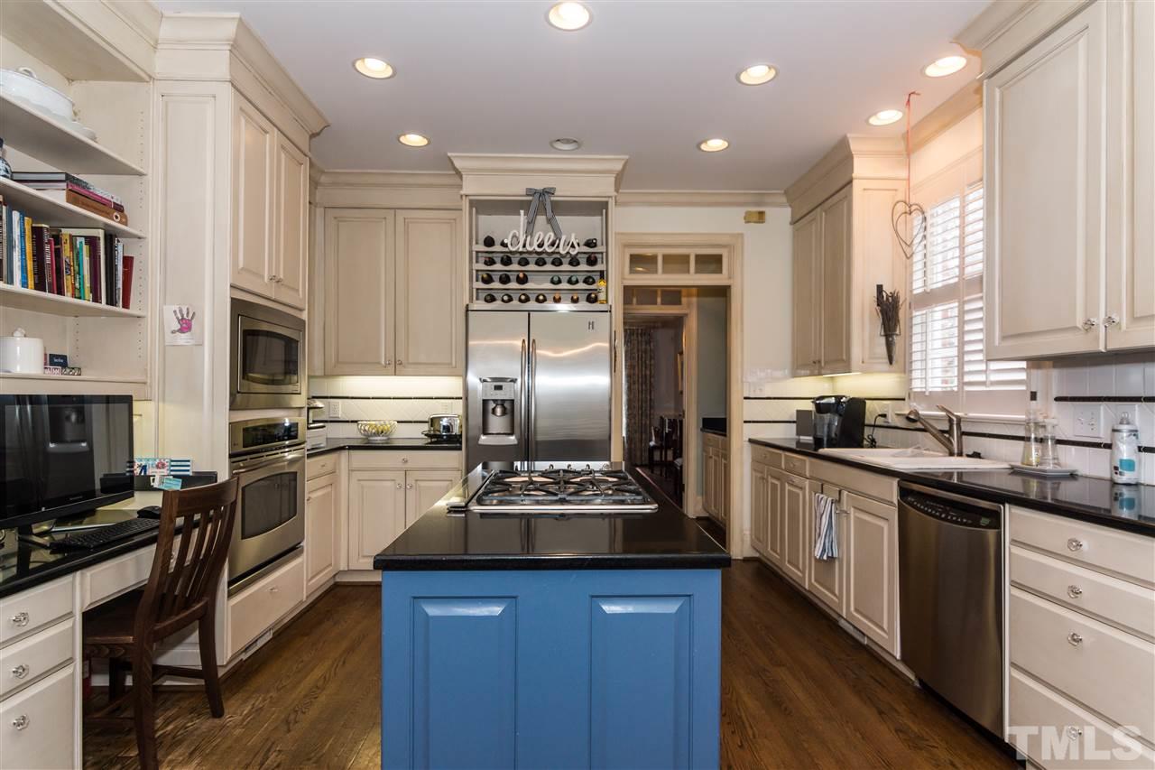 1712 Craig Street Raleigh, NC 27608 - Photo 6 of 25 a kitchen with stainless steel appliances kitchen island granite countertop a sink stove and refrigerator