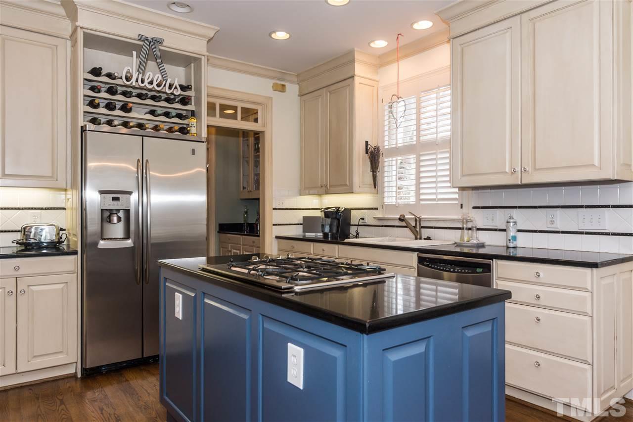 1712 Craig Street Raleigh, NC 27608 - Photo 7 of 25 a kitchen with granite countertop a sink stainless steel appliances and cabinets
