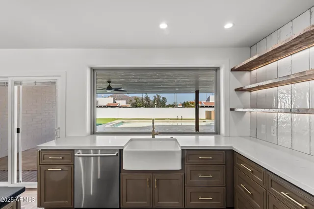 a view of a kitchen with a sink and a window