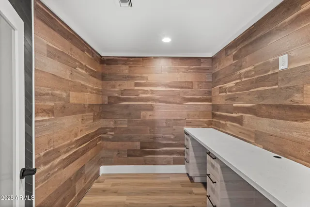 a view of empty room with wooden floor