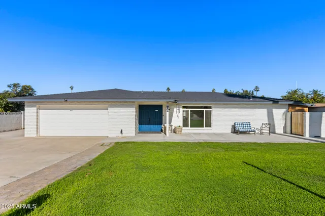 a house view with a sitting space and garden