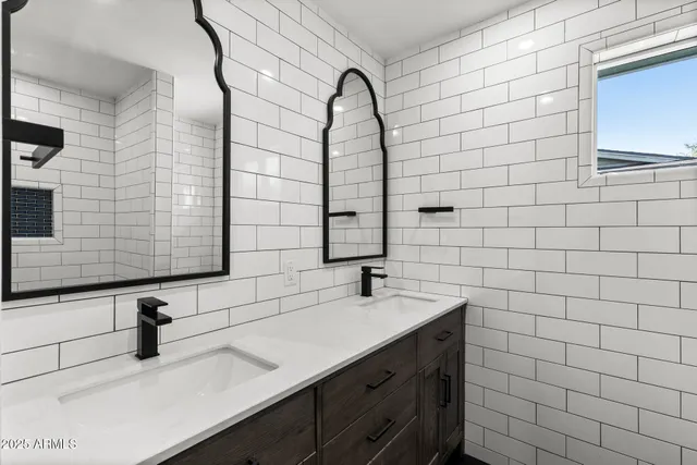 a view of a white house with a yard and sitting area