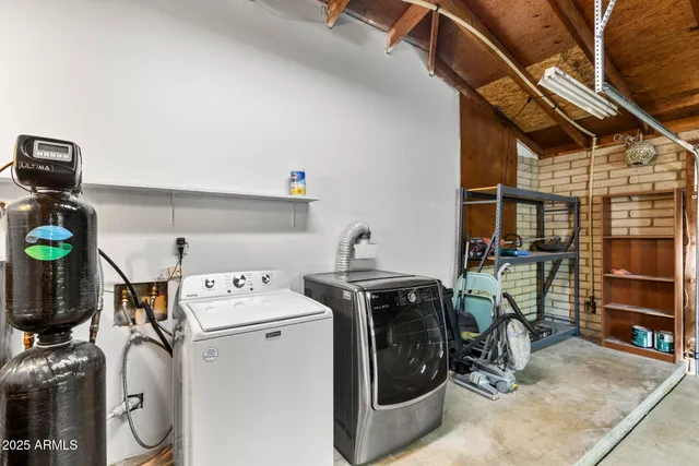 an aerial view of a house with a garden and mountain view in back