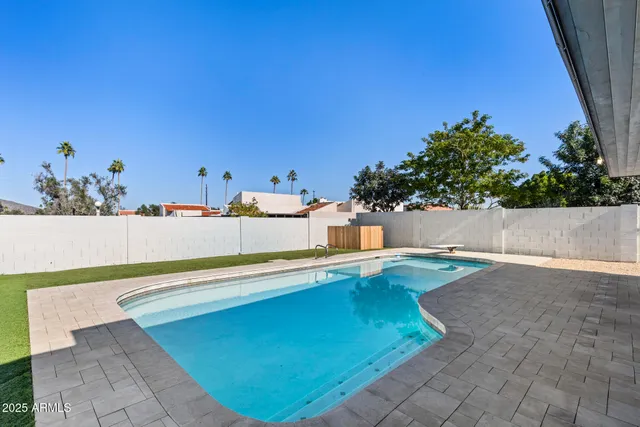 a view of a patio with table and chairs with wooden floor and fence