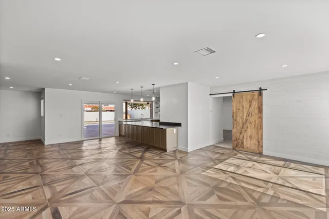 a view of a bedroom with wooden floor and closet