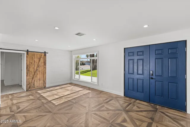 a kitchen with stainless steel appliances granite countertop a sink a counter space and a window