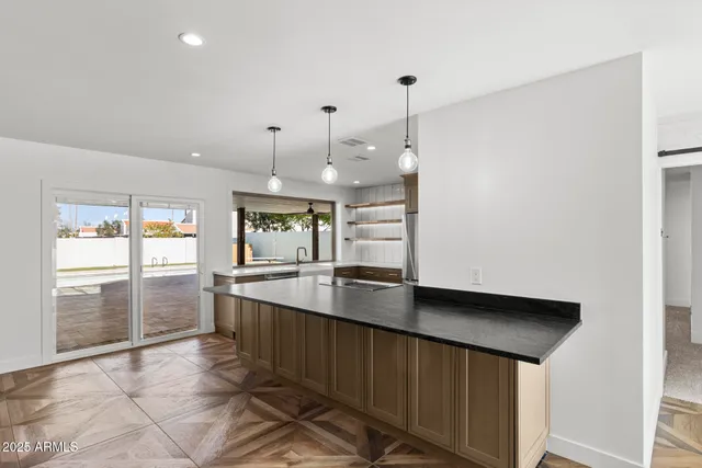 a large kitchen with stainless steel appliances a large counter top