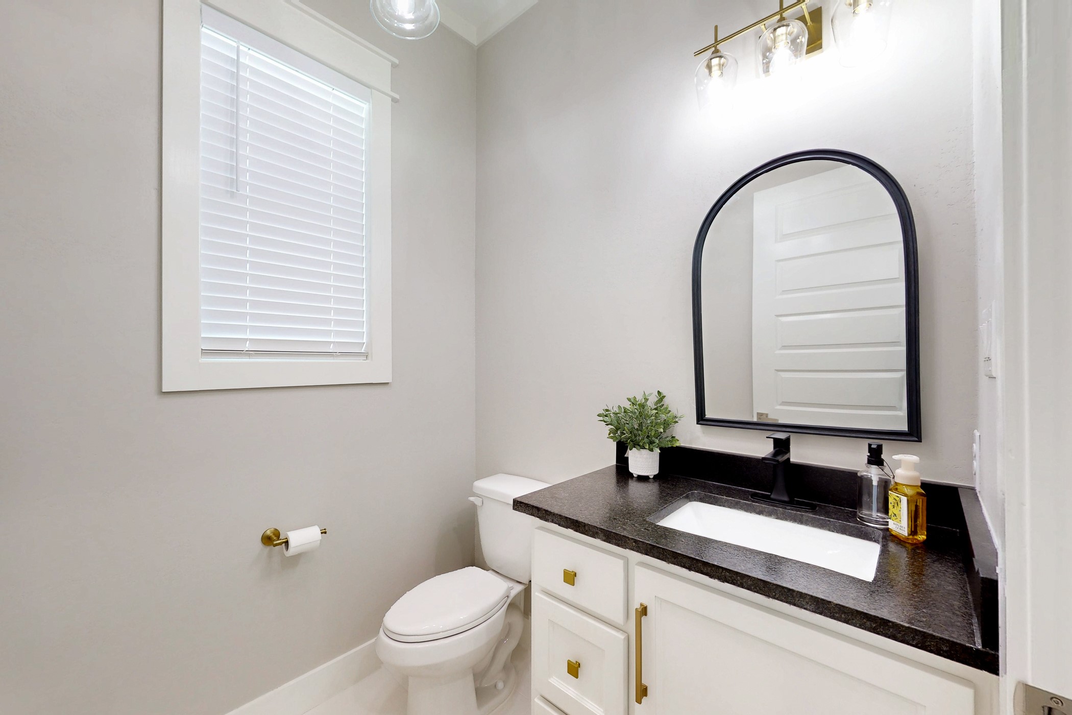 13504 Hudson Farms Road Franklin, TX 77856 - Photo 16 of 49 a bathroom with a granite countertop sink a toilet and a mirror