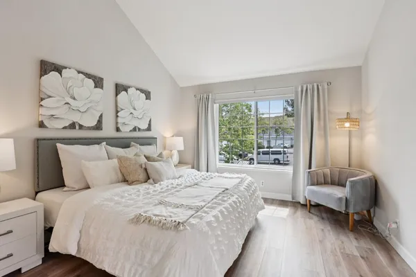 a bedroom with a large bed and a large window