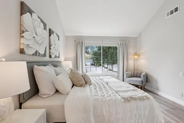 a living room with furniture a rug and a large window