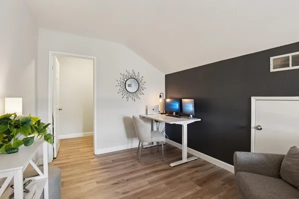 a living room with furniture and wooden floor
