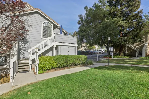 a front view of a house with a garden and plants